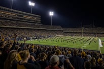 Packed College Football Stadium at Night Under Stadium Lights