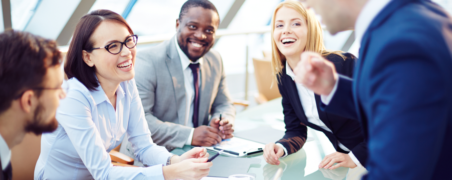 Business people laughing together at meeting