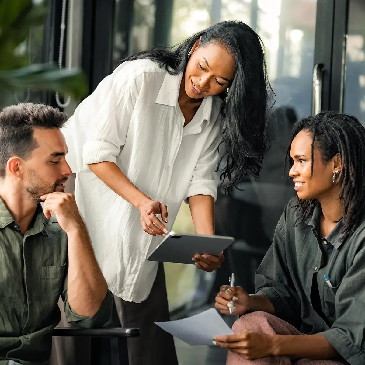 Three colleagues collaborate in a modern office