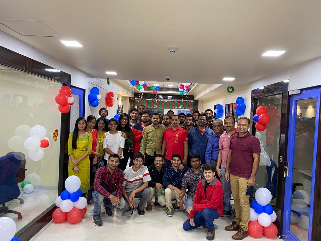Group of 24/7 Software employees surrounded by balloons