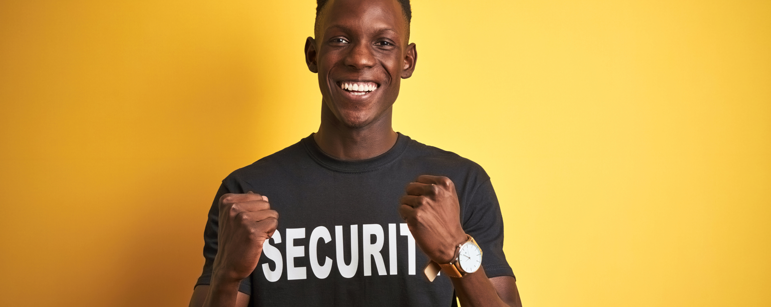 black security guard with arms raised for success