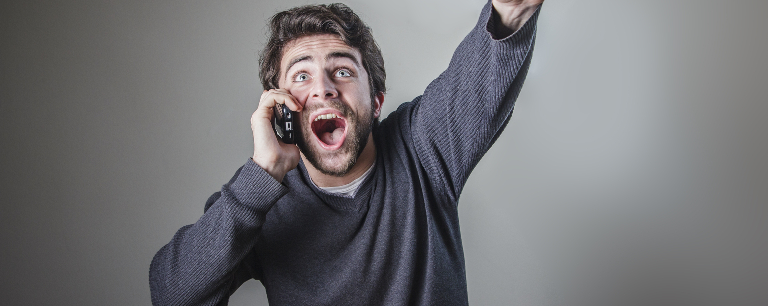 young man receiving great news over his cell phone