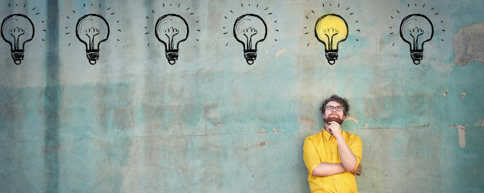 man standing against a wall thinking of idea