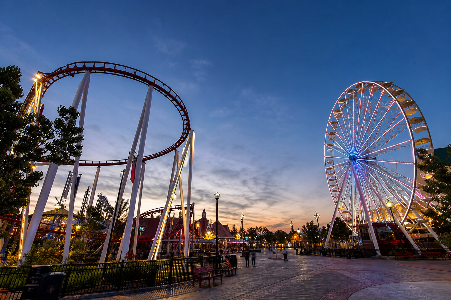 Vibrant Amusement Park at Dusk with Roller Coaster and Ferris Wheel