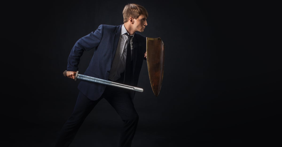 Businessman with shield and sword