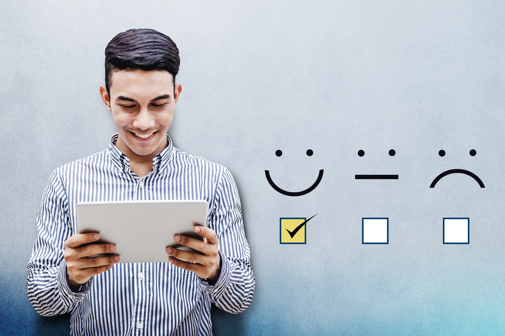 Happy Businessman holding digital Tablet with a checked box on Excellent Smiley Face Rating for a Satisfaction Survey
