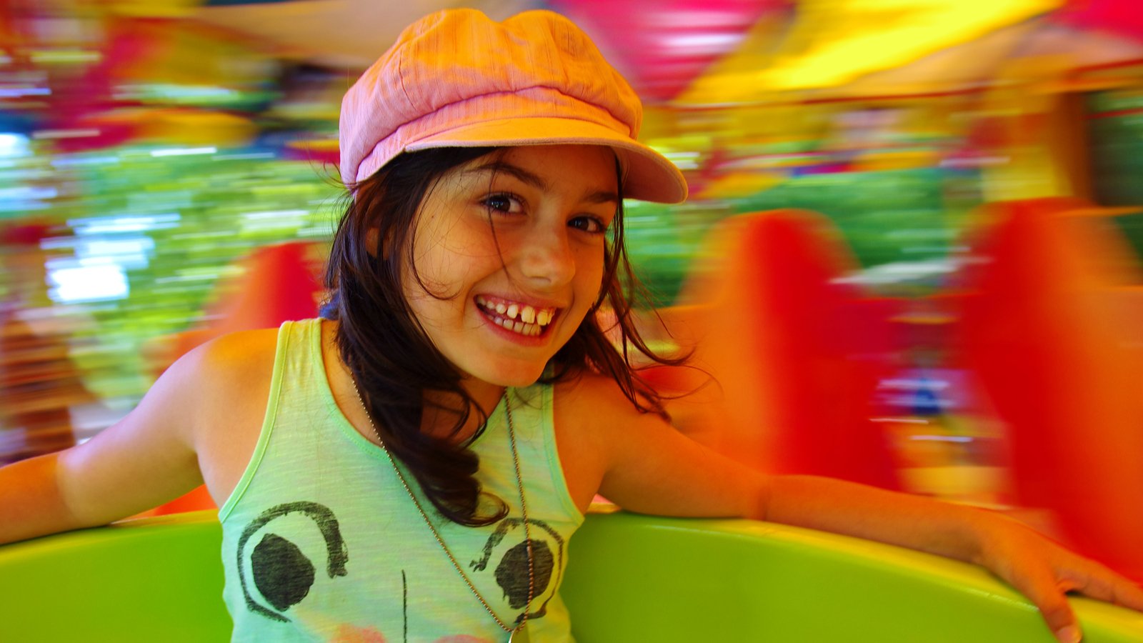 Little girl having fun in a carousel