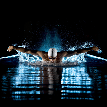 Taking-breath-swimming-butterfly-isolated-black-background