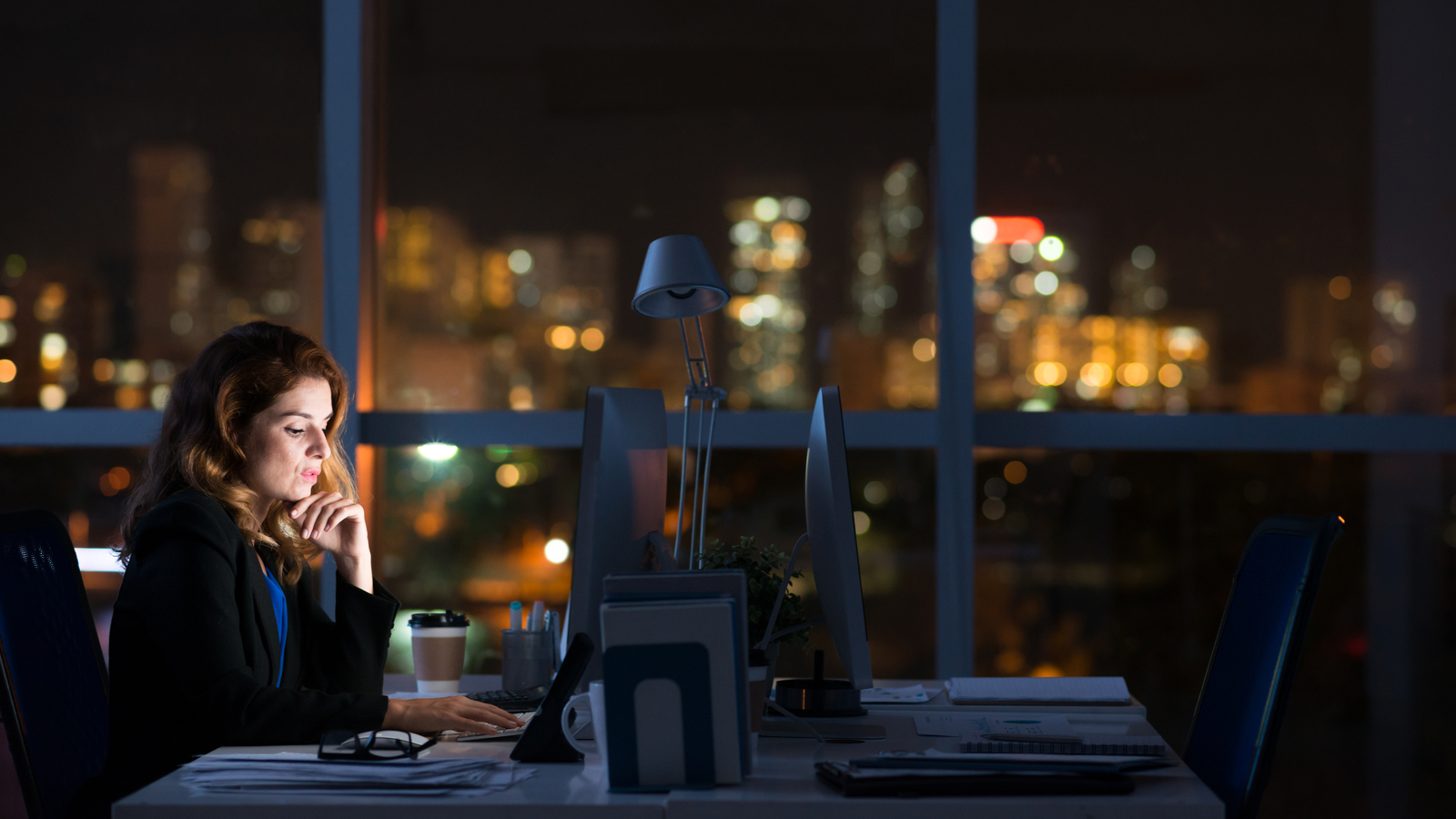 Business woman working alone in dark office
