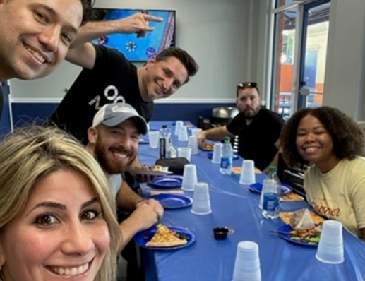 team smiling together at lunch