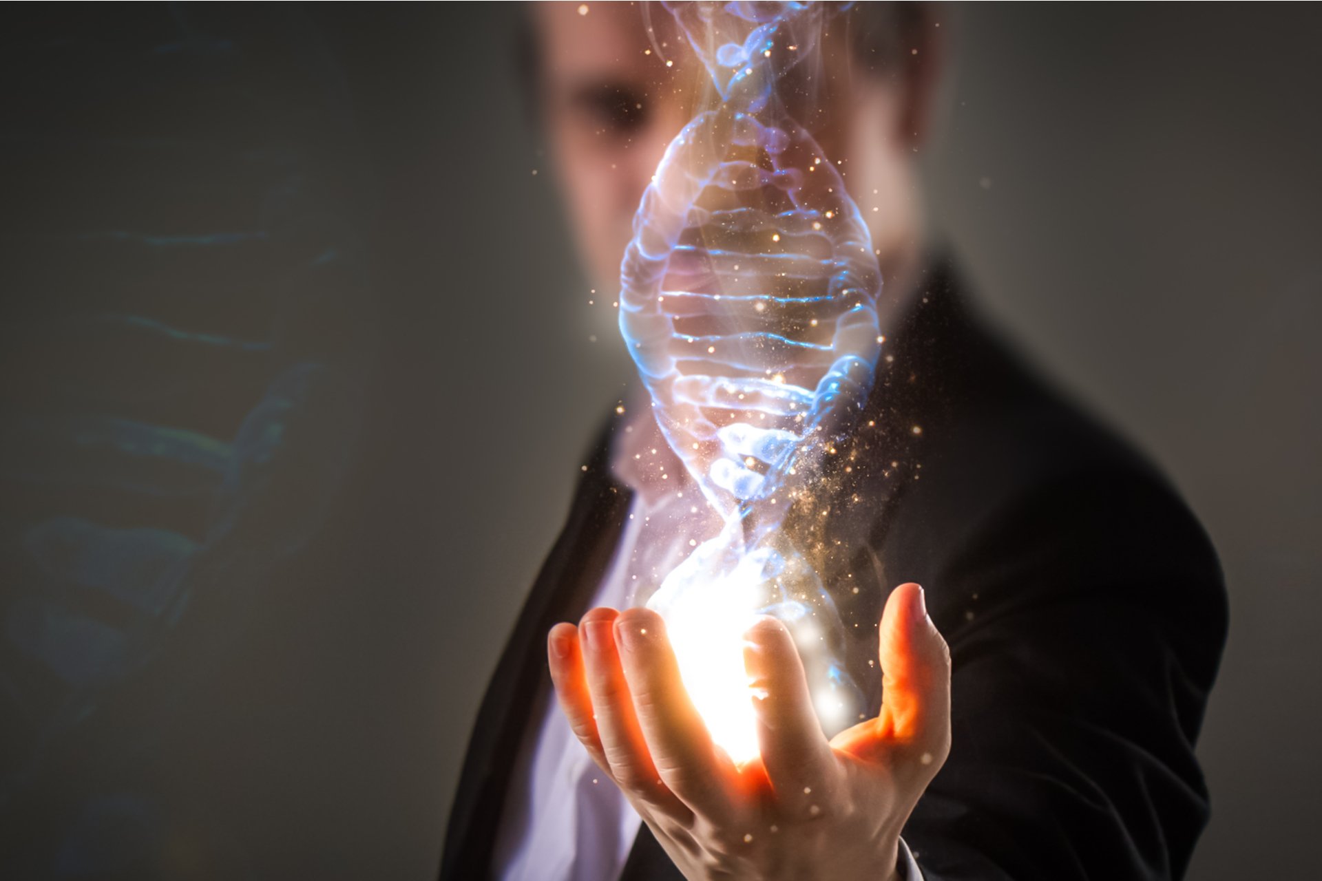 close up of Businessman holding glowing DNA helix with energy sparks